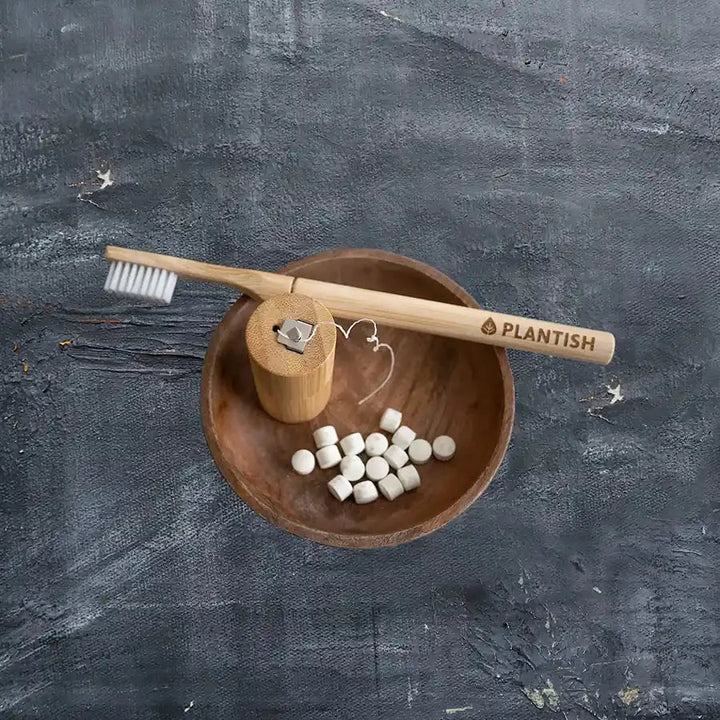 Bamboo toothbrush, eco friendly floss, and toothpaste tablets.