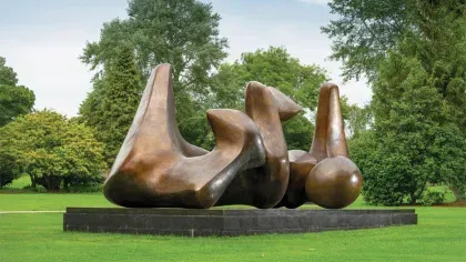 A Henry Moore sculpture surrounded by trees 