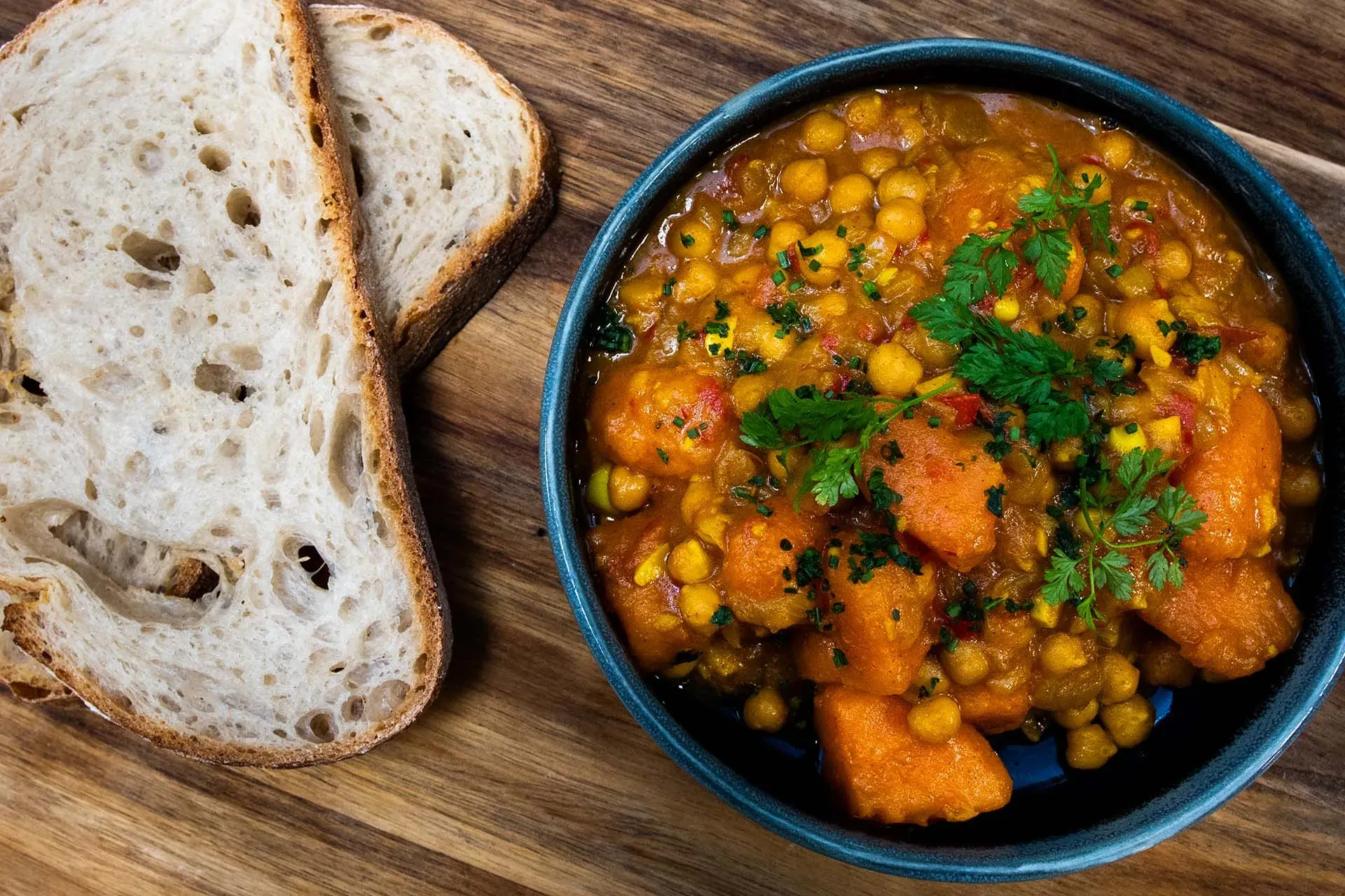 Two slices of sourdough bread and a bowl of squash and chickpea soup