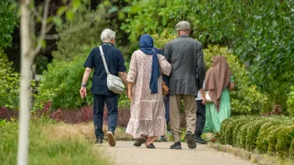 Volunteer leads friends through the Winter Garden