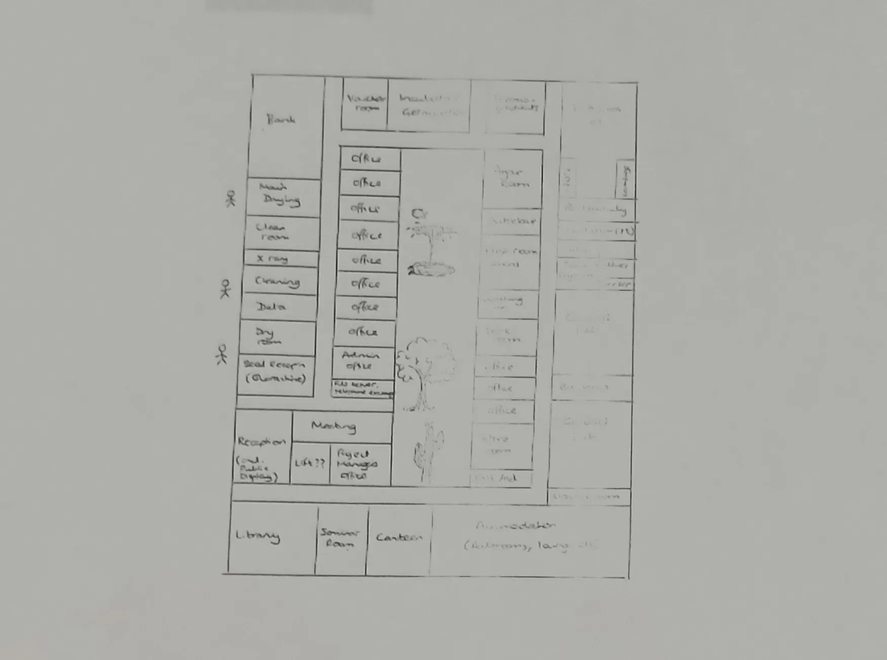 An old paper map shows a square building layout and multiple rooms marked out for offices or work areas