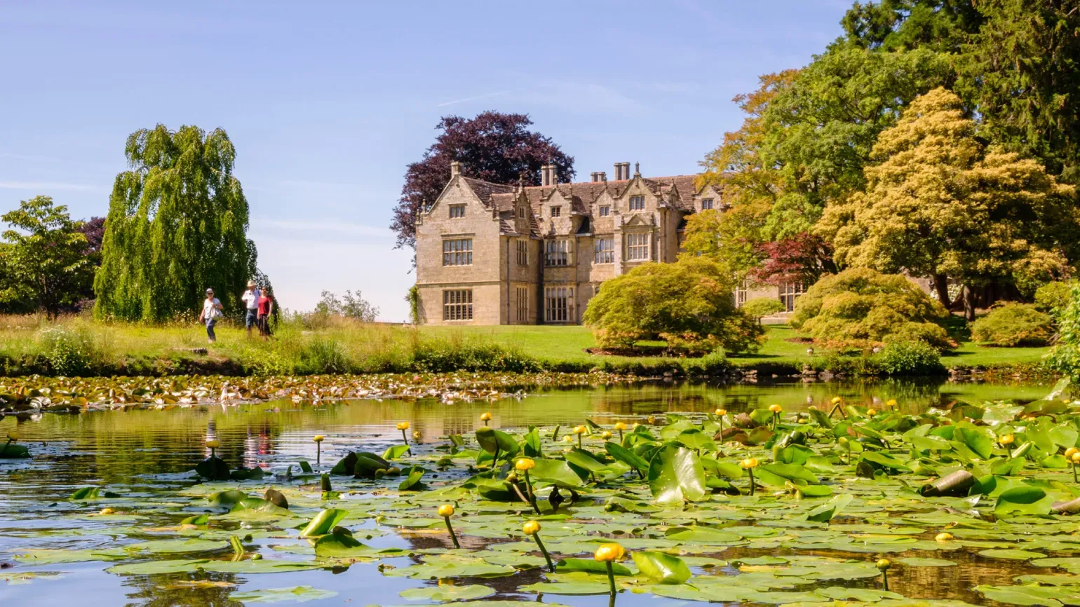 View of the mansion at Wakehurst from across the Mansion Pond.
