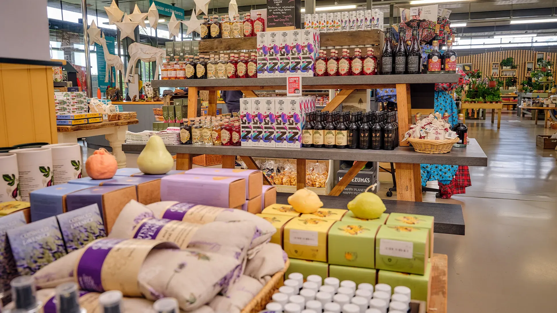 Shelves of products in the Wakehurst shop, including beauty products and drinks.