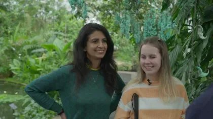 Konnie Huq and teenage disability activist Eleanor Stollery stand side by side against a lush backdrop of plants