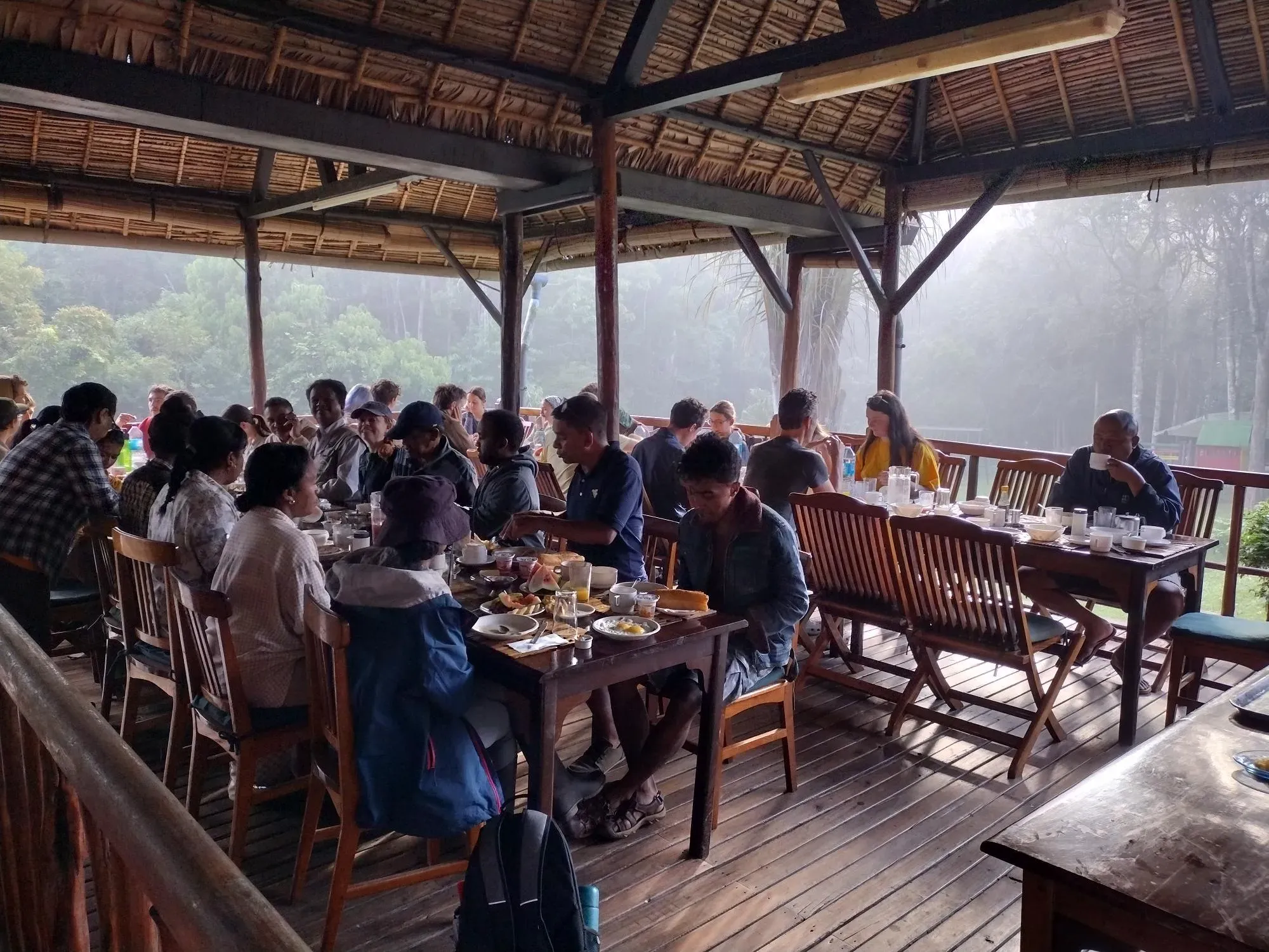 Around 30 people sitting at tables eating