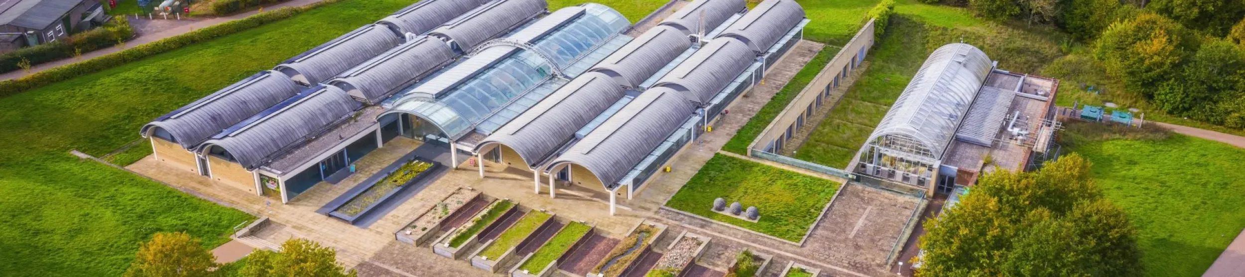 Large glasshouse in a green landscape from above